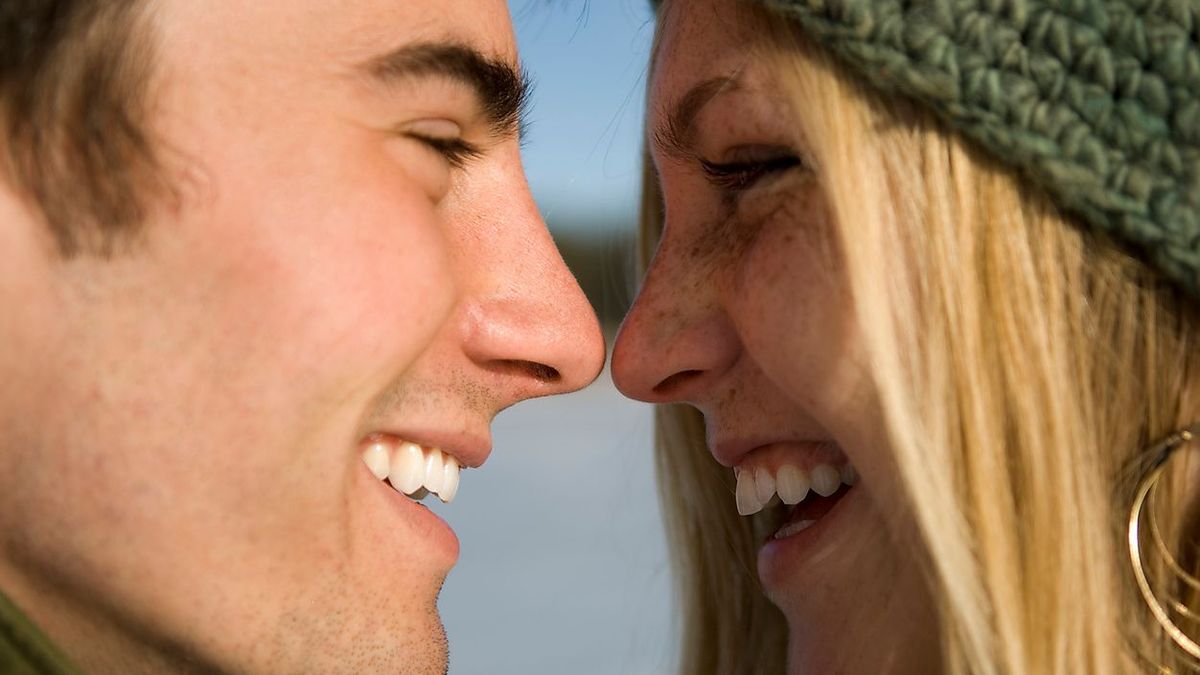 Young couple outdoors on frozen pond.