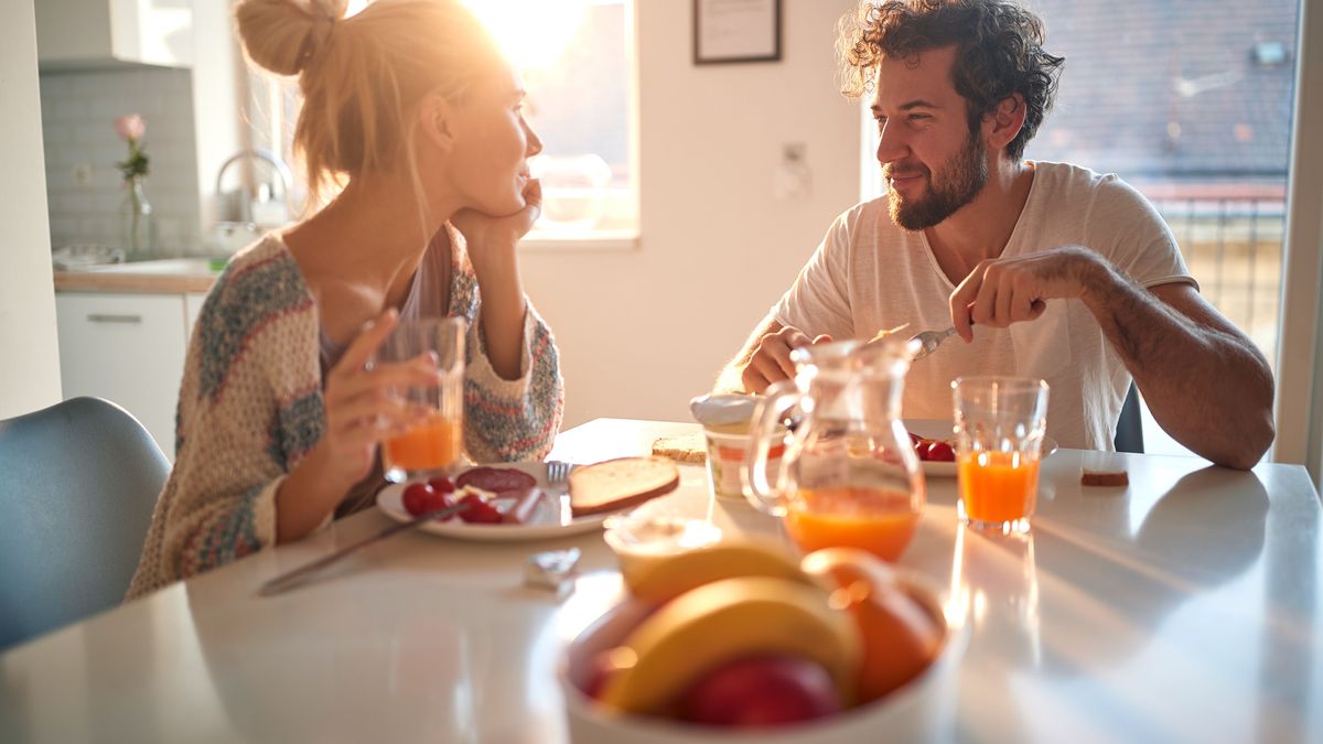 A young couple in love having romantic moments while having a breakfast at home. Relationship, love, together, breakfast