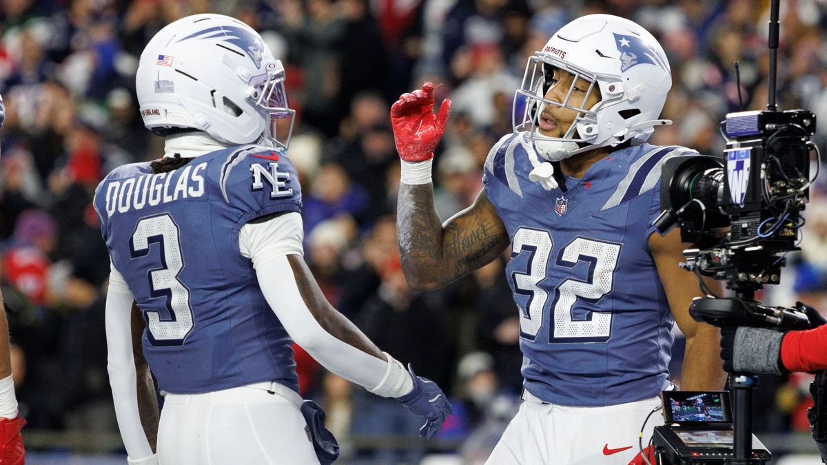 New England Patriots running back TreVeyon Henderson, right, celebrates his touchdown with New England Patriots wide receiver DeMario Douglas, left, during the first half against the New York Jets ...