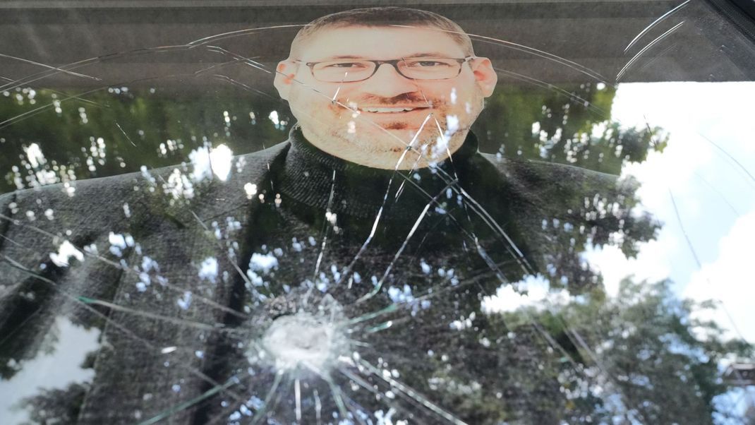 6. August 2024, Berlin: Eine Scheibe mit dem Konterfei des SPD-Abgeordneten Lars Düsterhöft an seinem Wahlkreisbüro hat ein Einschussloch. Unbekannte haben die Fassade mit der Parole "We condemn Germany 4 genocide." ("Wir verurteilen Deutschland für den Völkermord") besprüht und geschossen.