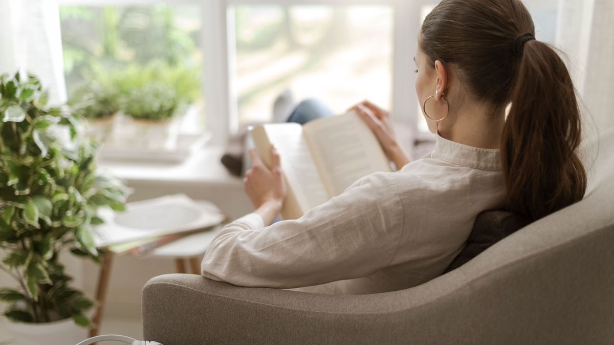 Woman relaxing and reading a book