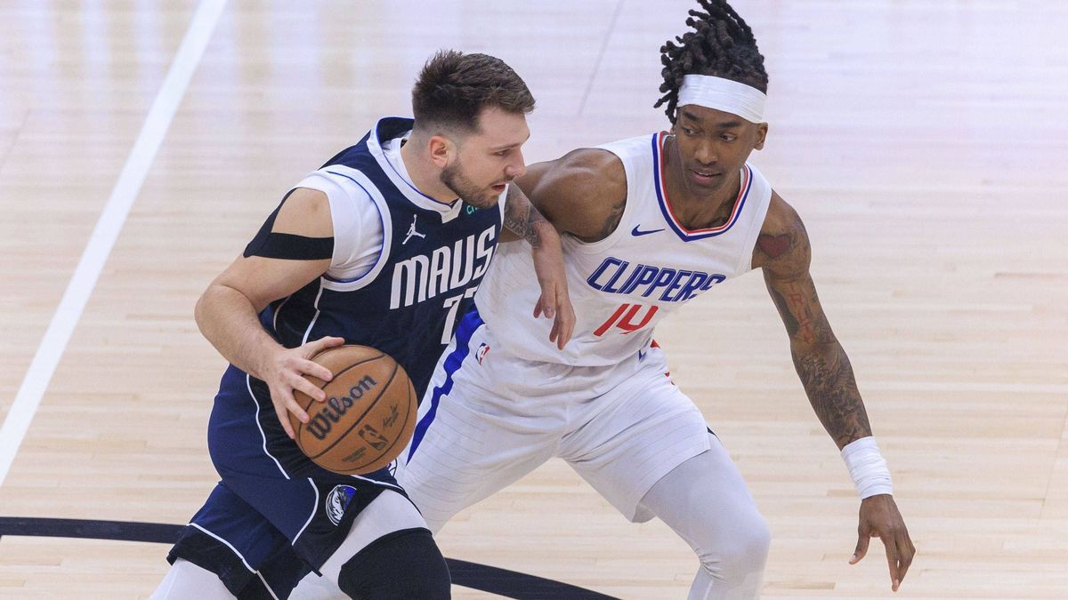 May 1, 2024, Los Angeles, California, USA: Terance Mann 14 of the Los Angeles Clippers defends against Luka Doncic 77 of the Dallas Mavericks during their NBA, Basketball Herren, USA Playoff game f...