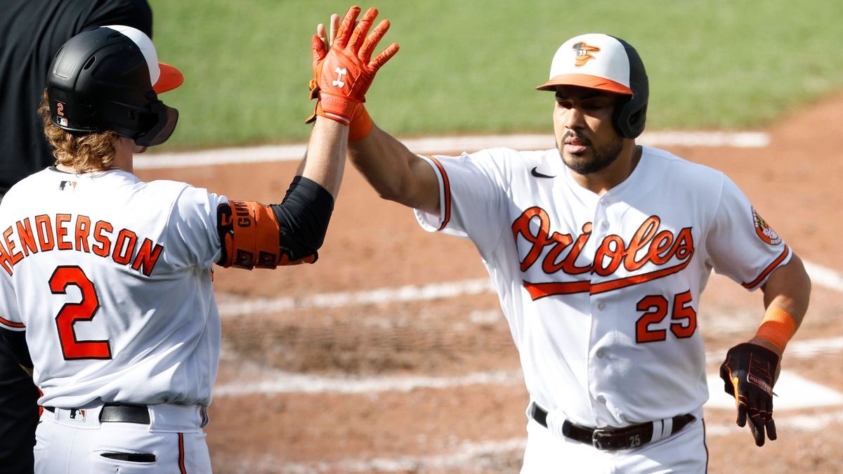 Baltimore Orioles designated hitter Anthony Santander is congratulated by Gunnar Henderson after scoring on a double by Ryan Mountcastle in the fourth inning against the Texas Rangers in game one o...