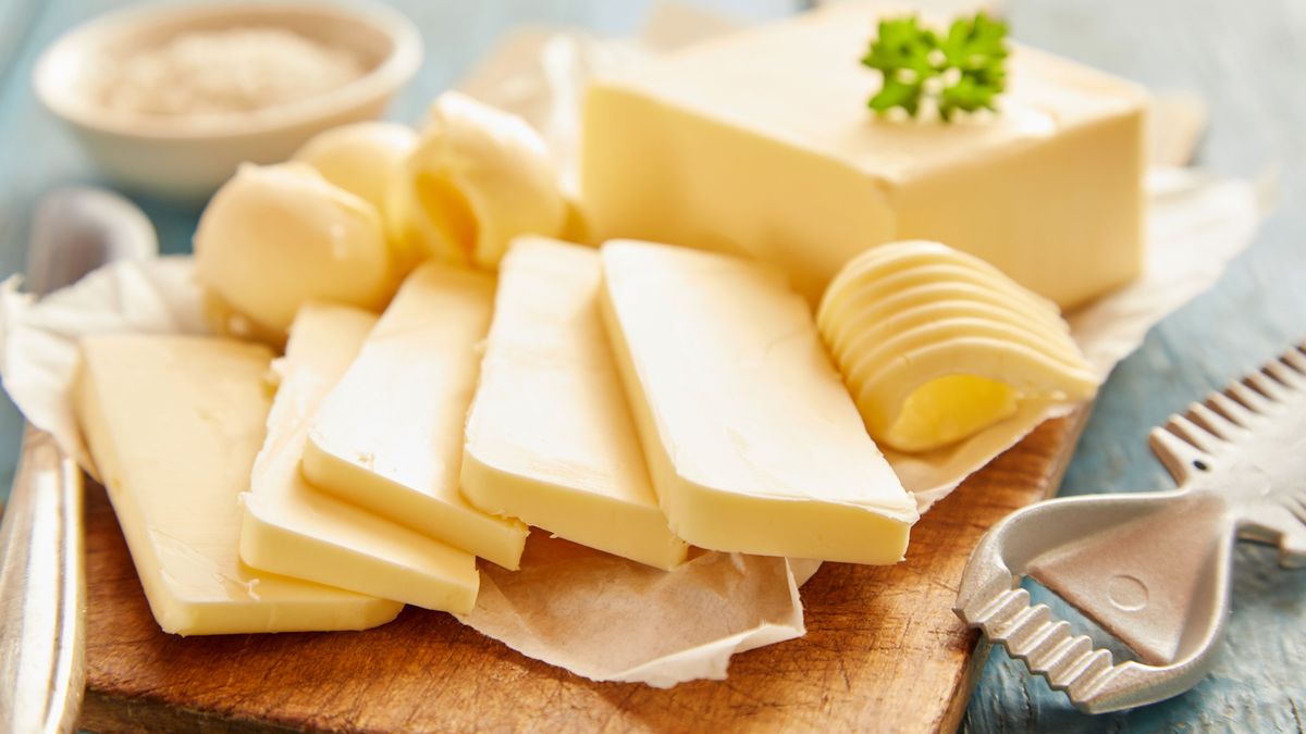 Close up view of butter sliced on cutting board