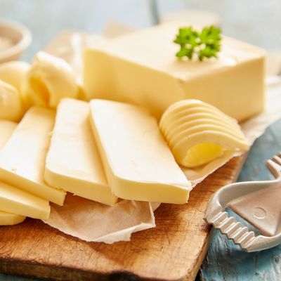 Close up view of butter sliced on cutting board