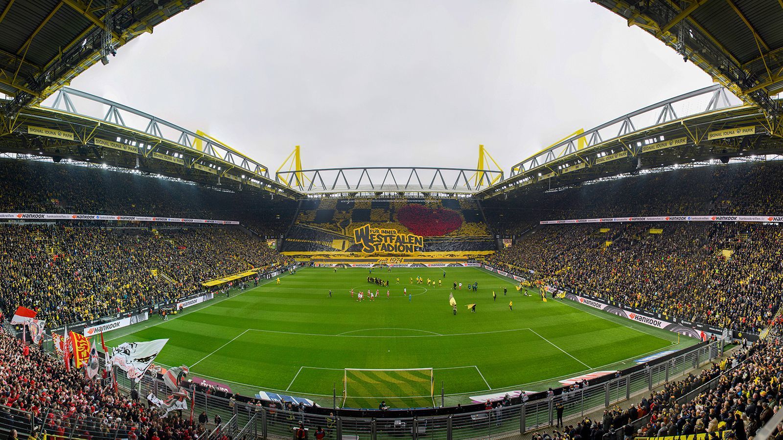 
                <strong>Borussia Dortmund</strong><br>
                • Aktueller Name: Signal Iduna Park<br>• Alter Name: Westfalenstadion<br>• Eröffnung des Stadions: April 1974<br>• Jahr der Übernahme: 2005<br>• Geld: <a href="/fussball/bundesliga/news/borussia-dortmund-bvb-choreo-westfalenstadion-signal-iduna-172614" data-url-id="51667">Wohl 100 Millionen Euro bis 2031</a><br>
              