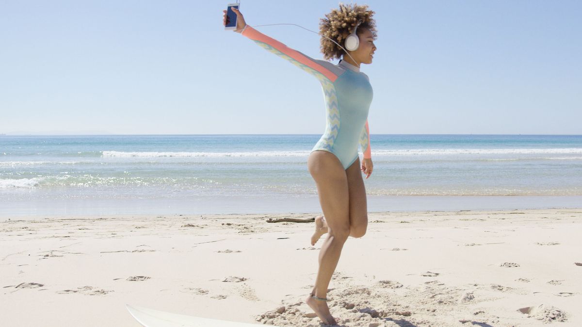 Female listening to music on beach