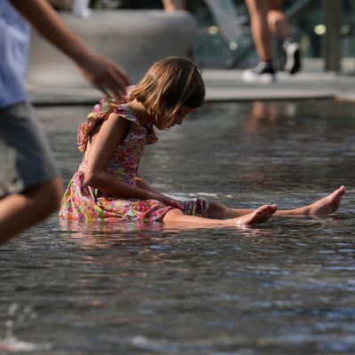 Italien, Mailand: Kinder erfrischen sich in einem Brunnen.