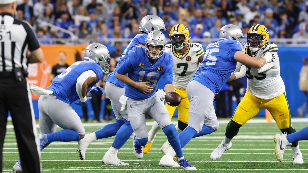 DETROIT, MI - NOVEMBER 23: Detroit Lions quarterback Jared Goff (16) hands the ball off to Detroit Lions running back David Montgomery (5) during a traditional Thanksgiving Day NFL, American Footba...