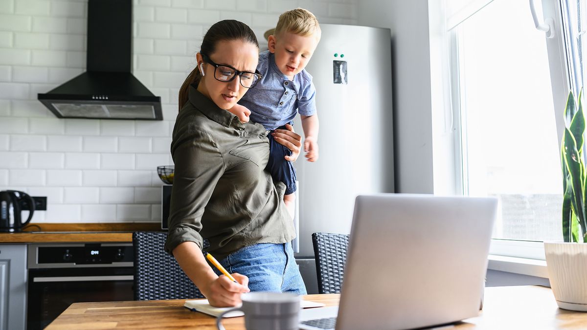 Mom works at home, toddler kid near