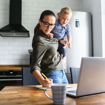 Mom works at home, toddler kid near