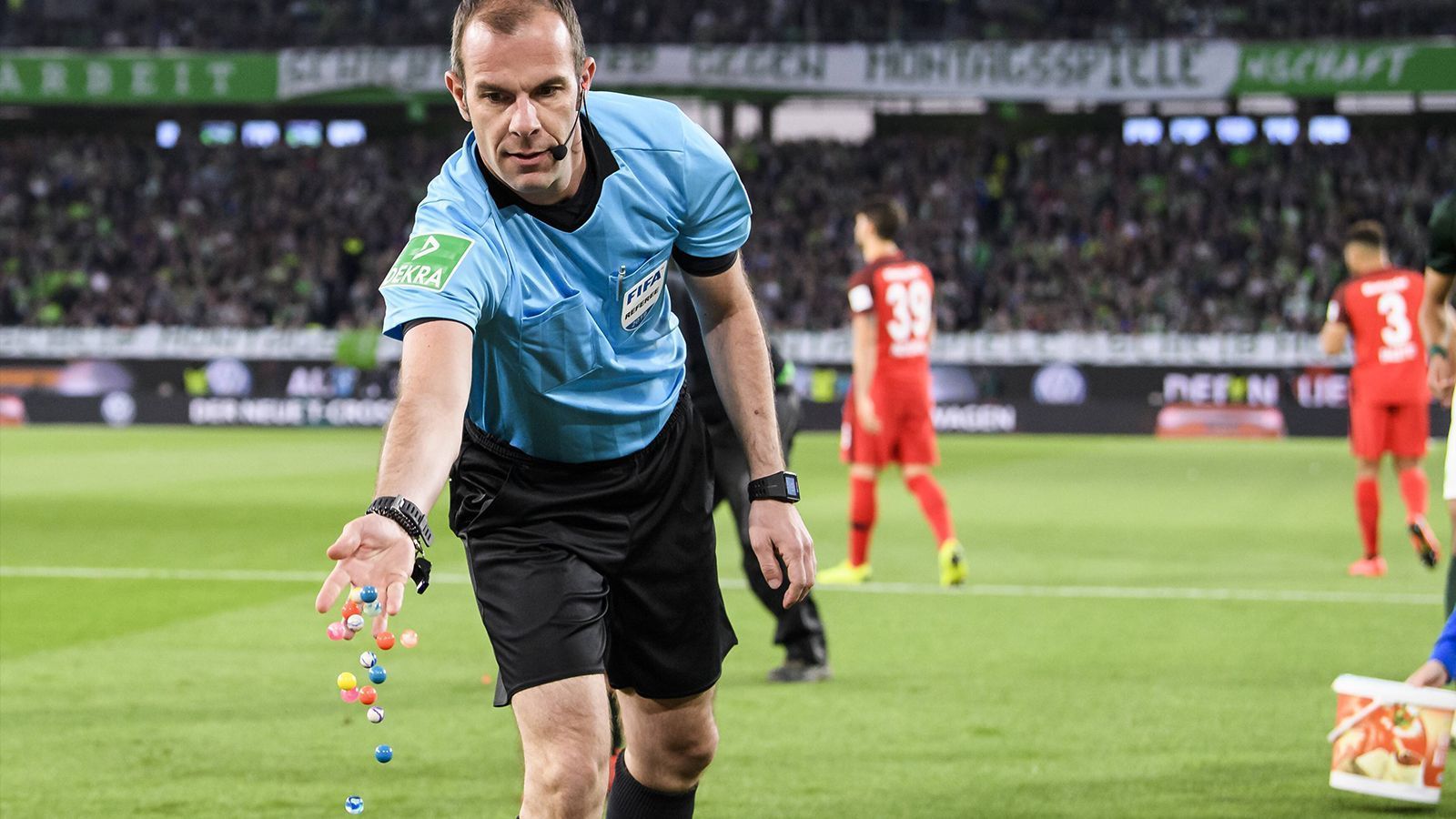 
                <strong>Spielunterbrechung wegen Ostereiern</strong><br>
                Nanu? Was macht Marco Fritz denn da? Einen auf Osterhase? Verteilt Eier an die Spieler? Oder gar die Fans? Nein, es ist mehr eine Reaktion auf eine Protestaktion er Frankfurter Fans beim wieder mal so ungeliebten Montagsspiel in der Bundesliga. Auch im Spiel zwischen dem VfL Wolfsburg und Eintracht Frankfurt demonstrieren die Anhänger beider Mannschaften gegen die angesetzten Spiele zum Wochenstart. Besonders einfallsreich sind dabei die Fans der Hessen.
              